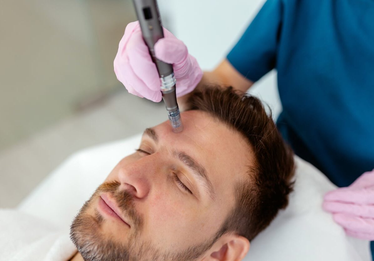 A Male Client Indulges in a Premium Skincare Experience at a Modern Clinic. A Professional Esthetician Performs a Non-invasive Facial Treatment Using a High-tech Device, Ensuring a Relaxing and Rejuvenating Session. The Client, Lies Comfortably on a Sleek Treatment Bed, His Serene Expression Reflecting Complete Relaxation. This Image Highlights the Growing Trend of Self-care Among Men, the Sophistication of Modern Dermatological Procedures, and the Advanced Technology Used in Professional Skincare Environments.
